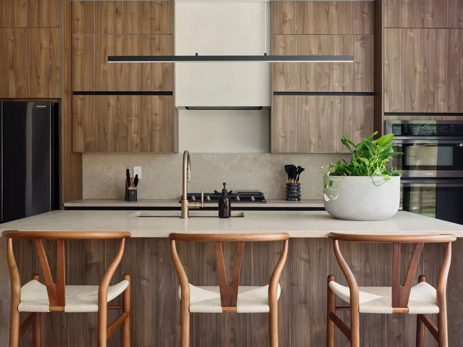 Warm walnut kitchen remodel with stone counters and professional appliances in Los Angeles — YBL Design & Build