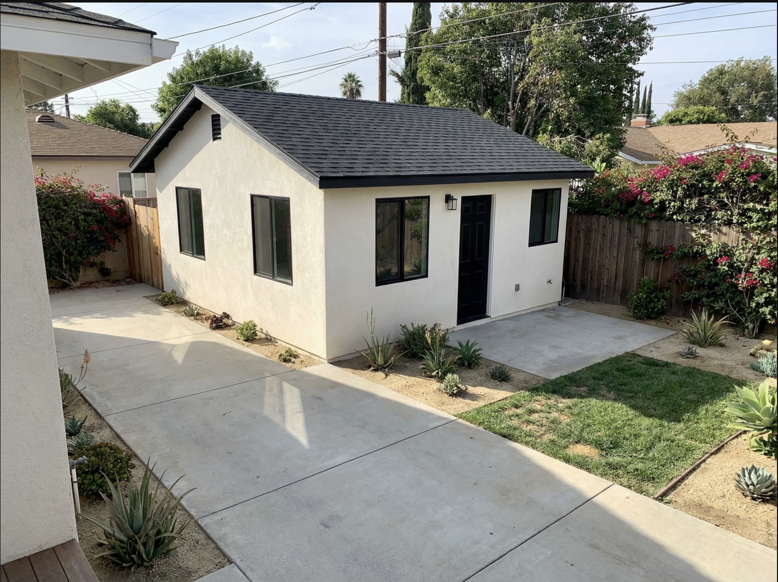 Garage conversion ADU shown with landscaped yard and concrete driveway in Los Angeles — YBL Design & Build